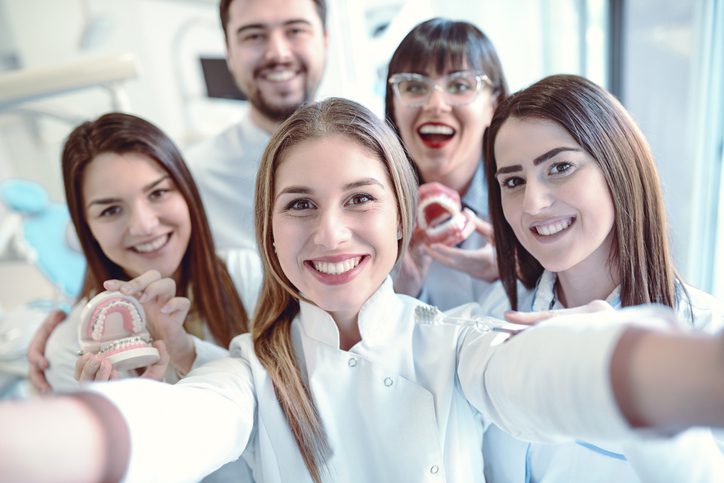 Dr. Cameron Auger & Associates is hiring. Image of dental staff.